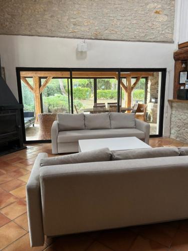 a living room with two couches and a fireplace at Domaine Saladry in Villepinte
