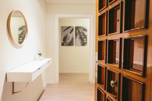 a bathroom with a sink and a mirror at The Lucky Flats - Belando Quintana in Alicante