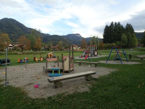 a park with a playground with a slide and swings at Chiemgauferienwohnungen - Wanderlust und Alpenrose in Unterwössen