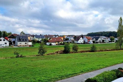 a suburb with houses and a green field at Privat Cozy Room in Mudau in Mudau