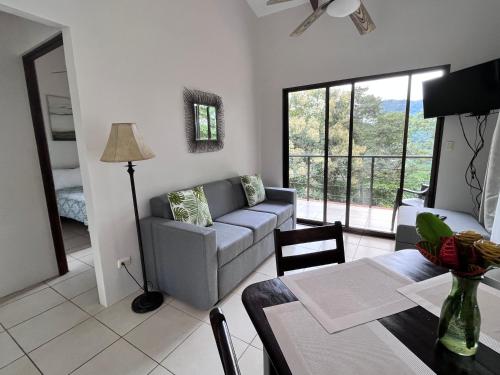 a living room with a couch and a table at Hotel Villas de la Colina in Atenas