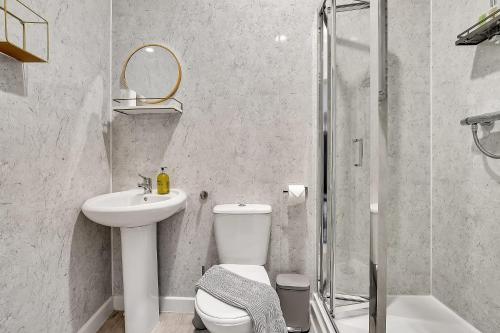 a bathroom with a toilet and a sink and a shower at The Abingdon in London