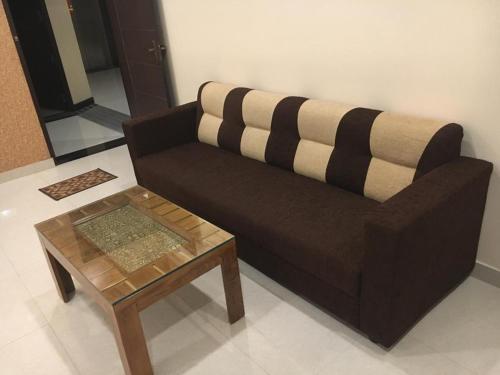 a living room with a couch and a coffee table at Vinayagam Residency in Arcot