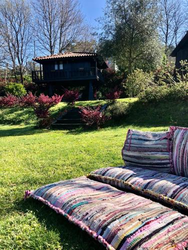 two blankets sitting on the grass in a yard at Quinta Lamosa Agroturismo in Arcos de Valdevez