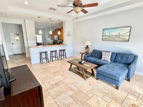 a living room with a blue couch and a table at Vistalmar Beach Resort in Deerfield Beach