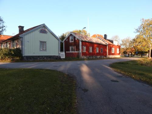 a group of houses on a street next to a road at Remarkable Harbour View Cabin. in Östhammar