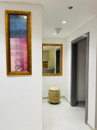 a room with two mirrors and a stool on a wall at Hill Top Holiday Homes Rental in Dubai