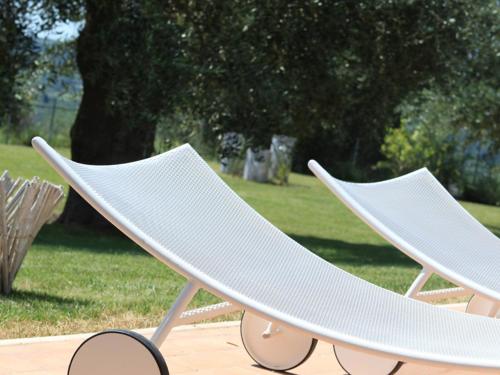 two white lounge chairs sitting next to each other at Hotel Giardino Giamperduto in Bernalda