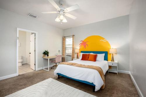 a bedroom with a large bed with a colorful headboard at Your UF Getaway: 1 Block from Campus - 4 BD Haven in Gainesville