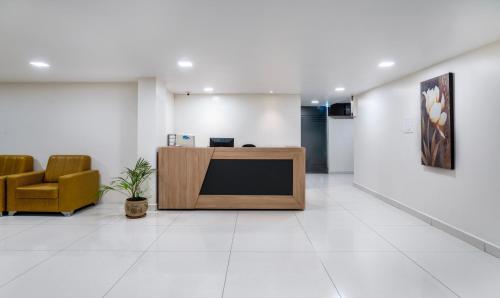 an office lobby with a reception desk and a chair at Treebo Trend Emerald in Hyderabad