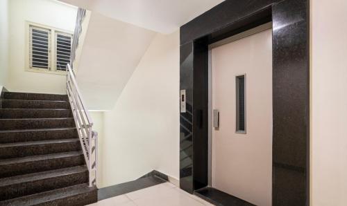 a hallway with a staircase and a door at Treebo Emerald in Hyderabad