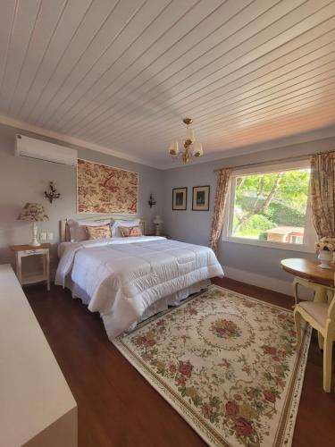 a bedroom with a large bed and a window at La Belle Provence in Itaipava