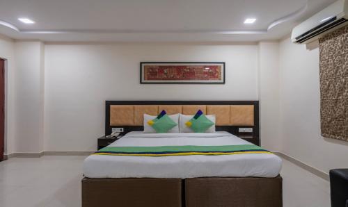 a bedroom with a large bed in a room at Treebo Emerald in Hyderabad