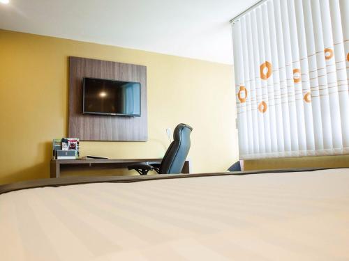 TV a/nebo společenská místnost v ubytování HOTEl DIBENI PEREIRA