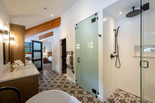 a bathroom with a shower and a toilet and a sink at Newly renovated 4-bed, bath ski-in, ski-out with fireplaces, private hot tub, and private garage! in Whistler