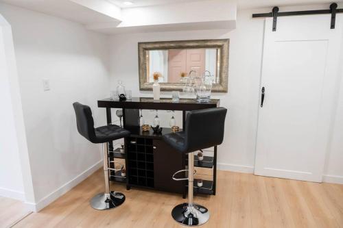 a barber shop with two chairs and a mirror at Riverfront Cottage Canoe Included & Playroom Fun in Wasaga Beach
