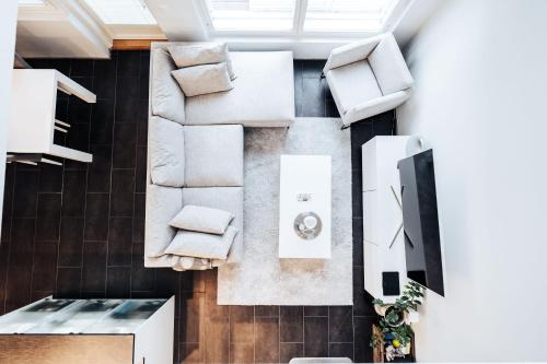 an overhead view of a living room with white furniture at Apartment next to Ounasvaara and city centre in Rovaniemi