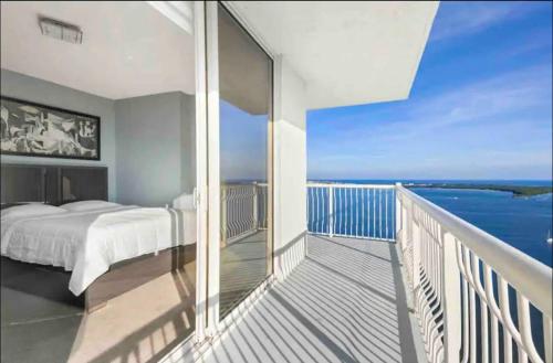 a bedroom with a bed on a balcony with the ocean at Stunning 2Br Condo brickell-Waterviews-FreeParking in Miami