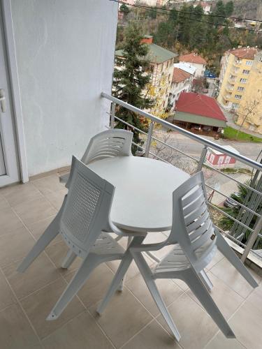 a white table and two chairs on a balcony at CAN APART KAPLICA OTEL in Termal
