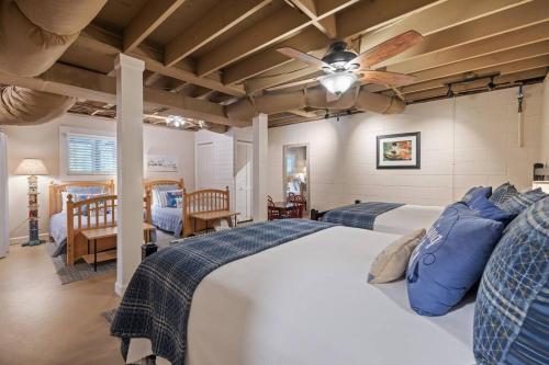 a bedroom with two beds and a ceiling fan at Water's Edge-Lakefront Cabin W/Dock, Views, Etc. in Winchester