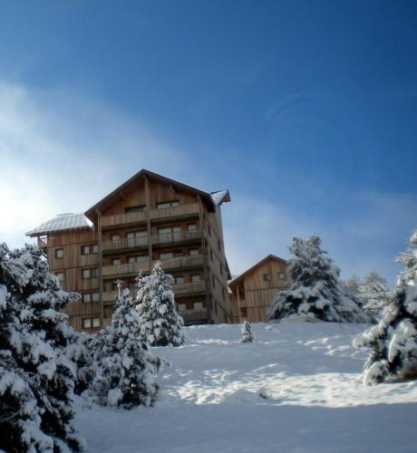 a lodge in the snow with snow covered trees at Super Devoluy Cosy apartment close to the slopes in Le Dévoluy