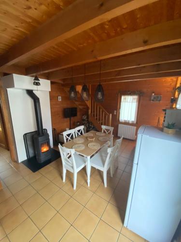 a dining room with a table and a wood stove at Chalet des 2 lacs in Xonrupt-Longemer