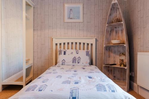 a bedroom with a bed with a wooden head board at The Bell Lodge in Sandown