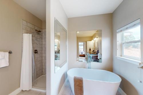 a white bathroom with a tub and a shower at Cottonwood Pass Retreat in Gypsum