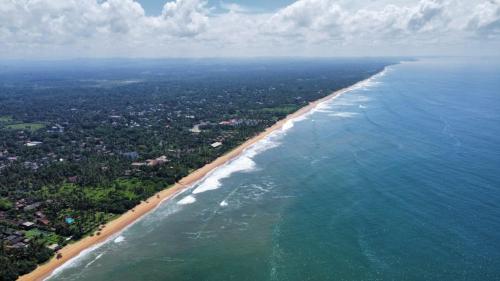 an aerial view of a beach and the ocean at Dhammika Beach Palace in Wadduwa