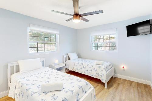 a bedroom with two beds and a ceiling fan at Seminole's Secret in Redington Shores