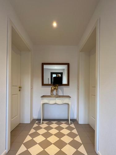 a room with a table and a mirror on the wall at Villa Rosenhof (2 Personen +) in Lindau