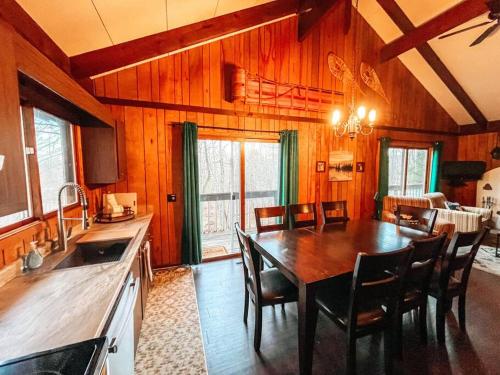 a kitchen and dining room with a table and chairs at Mountain Top Chalet ~ Ski In Out ~ Fully Updated in Bessemer