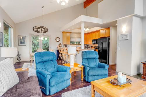 a living room with two blue chairs and a table at Girdwood Mountain Chateau in Girdwood