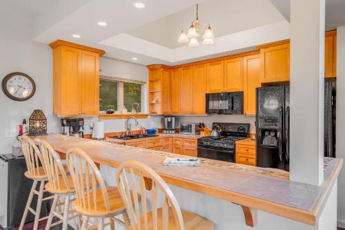 a kitchen with wooden cabinets and a large counter top at Girdwood Mountain Chateau in Girdwood