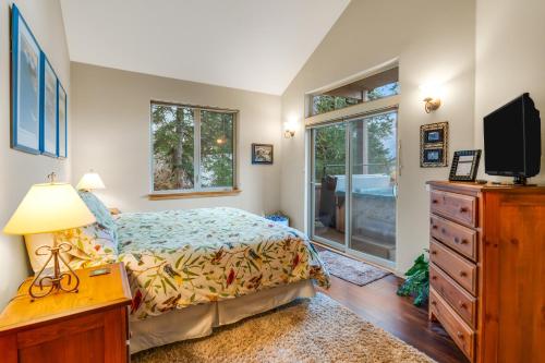 a bedroom with a bed and a dresser and a tv at Girdwood Mountain Chateau in Girdwood