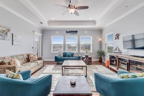 a living room with a couch and chairs and a table at The Blue Shell in Port Aransas