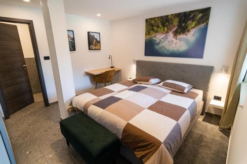 a bedroom with a large bed and a desk at Panorama 13 in Tolmin