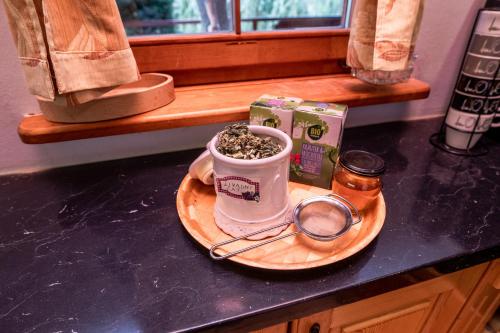 a cup of coffee sitting on a counter with a plate at Holiday Home Vitis in Selnica