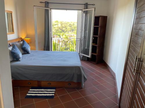 a bedroom with a bed and a large window at Picturesque Riverside 2-Bedroom Ensuite Villa in Port Chambly in Terre Rouge