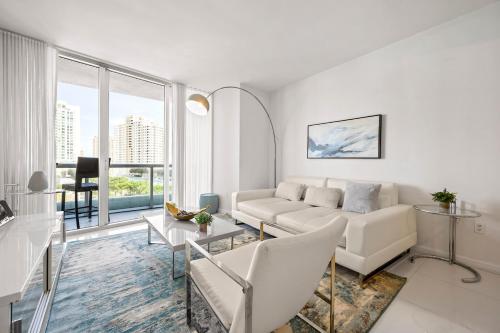 a white living room with a couch and a table at Luxury 1 BR Condo W Icon Brickell-Waterviews in Miami