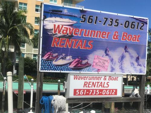 a large sign for aewater istg and boat rentals at Florida Seaside Get Away- 50 Steps to Beach in Boynton Beach