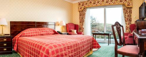 a hotel room with a bed and a window at Fernhill Hotel in Portpatrick