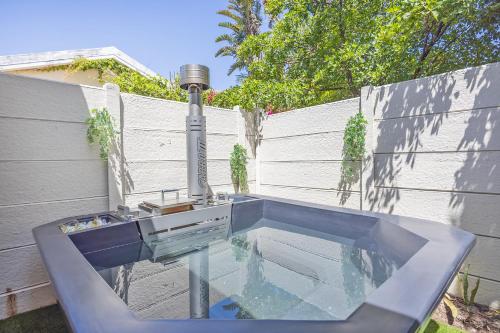 a swimming pool with a fountain in a backyard at Blouberg Studio Apartments in Bloubergstrand