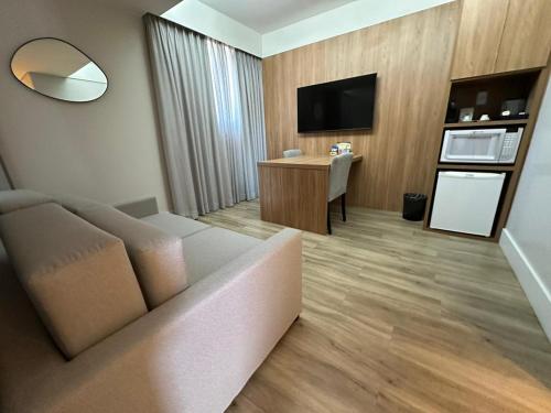 a living room with a couch and a table at H2 Platinum Lourdes in Belo Horizonte