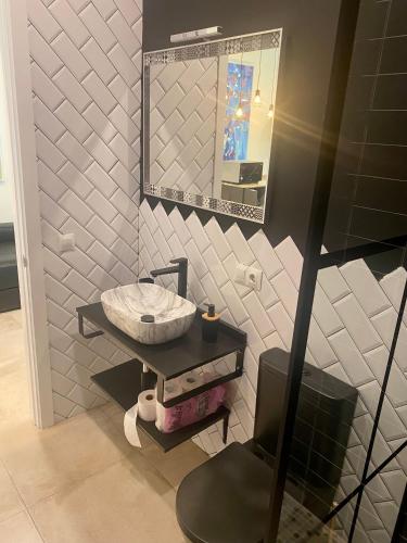 a bathroom with a sink and a mirror at La Macarena in Seville