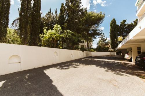 a white fence in front of a house at Cozy room on the beach in La Ciotat