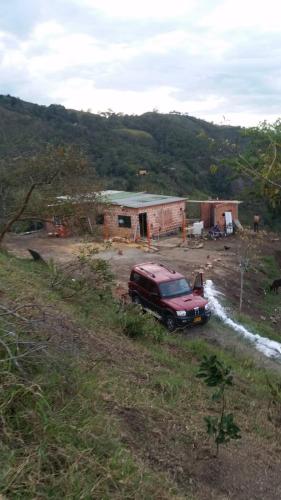 a red truck parked in front of a house at CABAÑAS CAMPO ALEGRE 