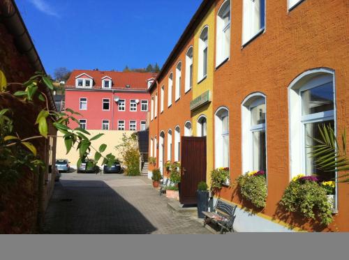 a street with buildings and a bench in a city at An der Porzellan-Manufaktur Pension in Meißen