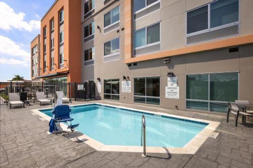 a swimming pool in front of a building at Holiday Inn Express & Suites - Hawaiian Gardens, an IHG Hotel in Hawaiian Gardens