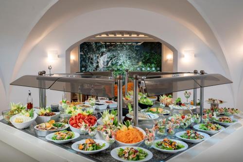 a buffet with many plates of food on a table at Le Hammamet Hôtel & Spa in Hammamet